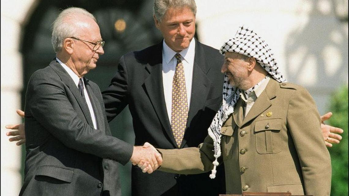Done deal? Israeli Prime Minister Yitzhak Rabin (left) and Palestine Liberation Organization Chairman Yasser Arafat (right) shake hands at the White House in front of President Bill Clinton in Sept. 13, 1993.