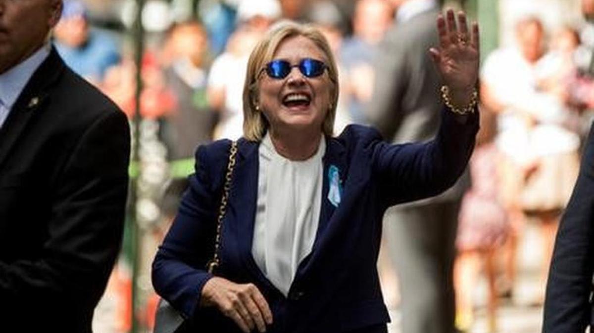 Hillary Clinton waves after leaving her daughter’s apartment were she went after feeling “overheated” at a 9/11 ceremony.