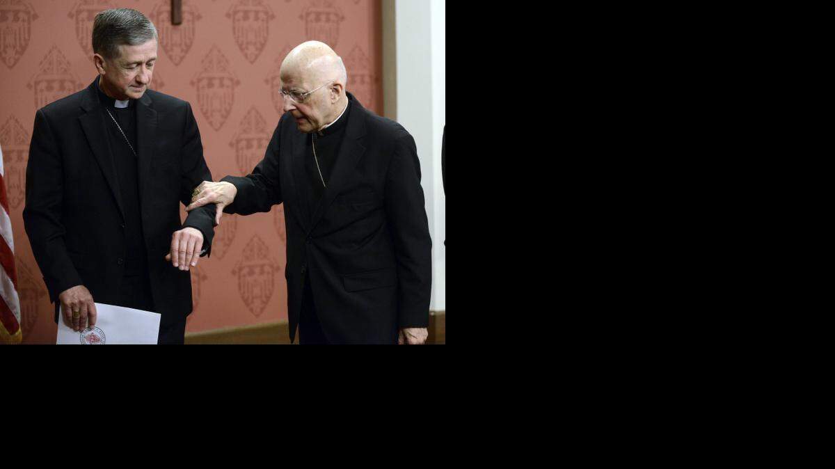 
POPE’S CHOICE: Cardinal Francis George, right, retiring leader of the Archdiocese of Chicago, walks away from the podium with help from his successor, Archbishop Blase Cupich.
