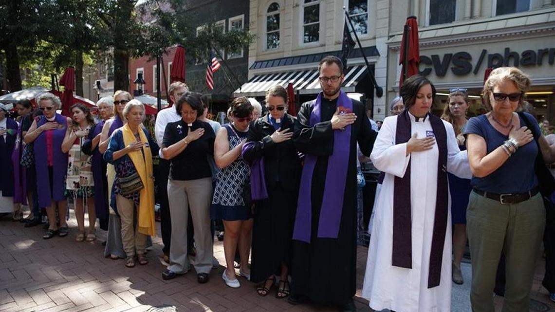 Members of the clergy stood among other mourners outside the memorial service for Heather Heyer in Charlotteville, Virginia. Heyer was killed during a white nationalist rally there.