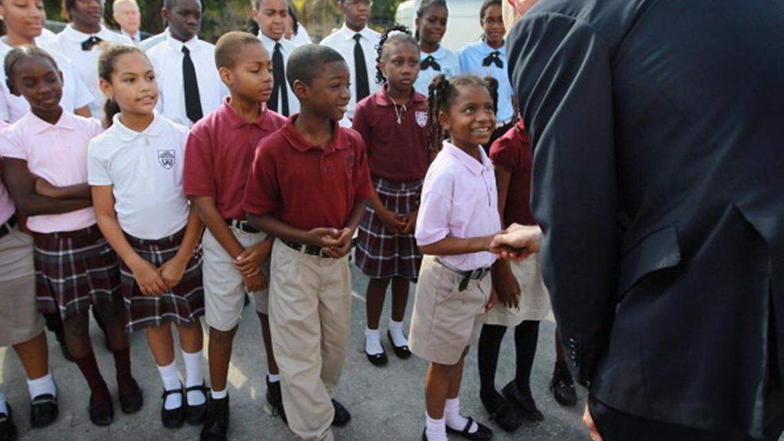 In 2011, Children wait to shake hands with Florida Gov. Rick Scott during his visit to the Florida International Academy charter school in Opa-locka.