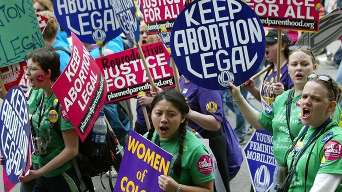 Women march in protest of efforts to curtail access to abortion.