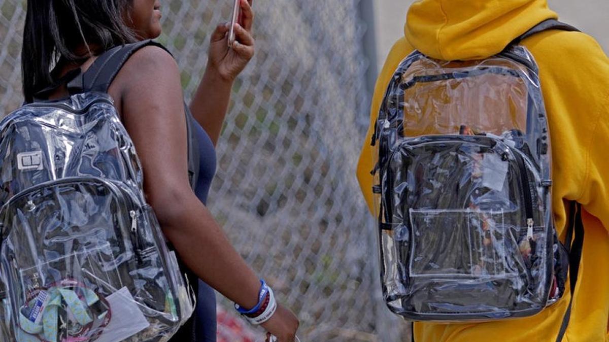 Students wear clear backpacks outside Marjory Stoneman Douglas High School. The bags are one of a number of security measures the Broward County school district has enacted as a result of the Feb. 14 shooting at the school that killed 17. Miami-Dade is considering a similar measure.