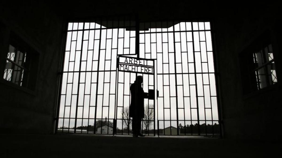 A man enters the Sachsenhausen death camp through the gate on International Holocaust Remembrance Day 2016.