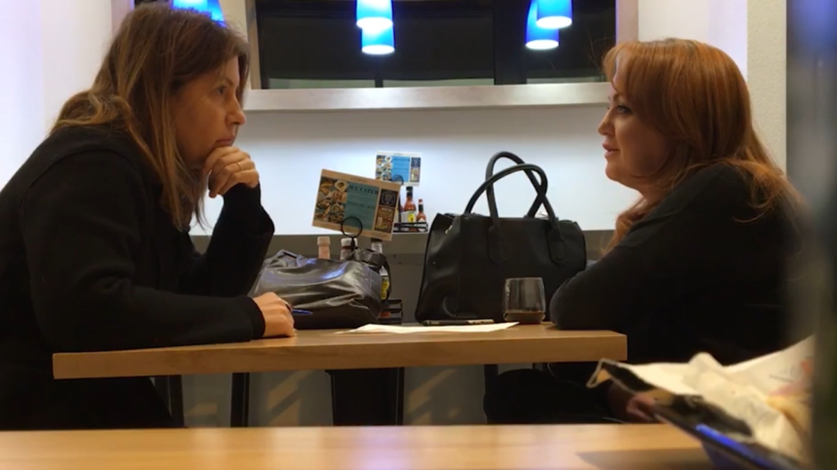 Reporter Stephanie McCrummen of The Washington Post, left, interviews Jaime Phillips at a restaurant in Alexandria, Virginia.