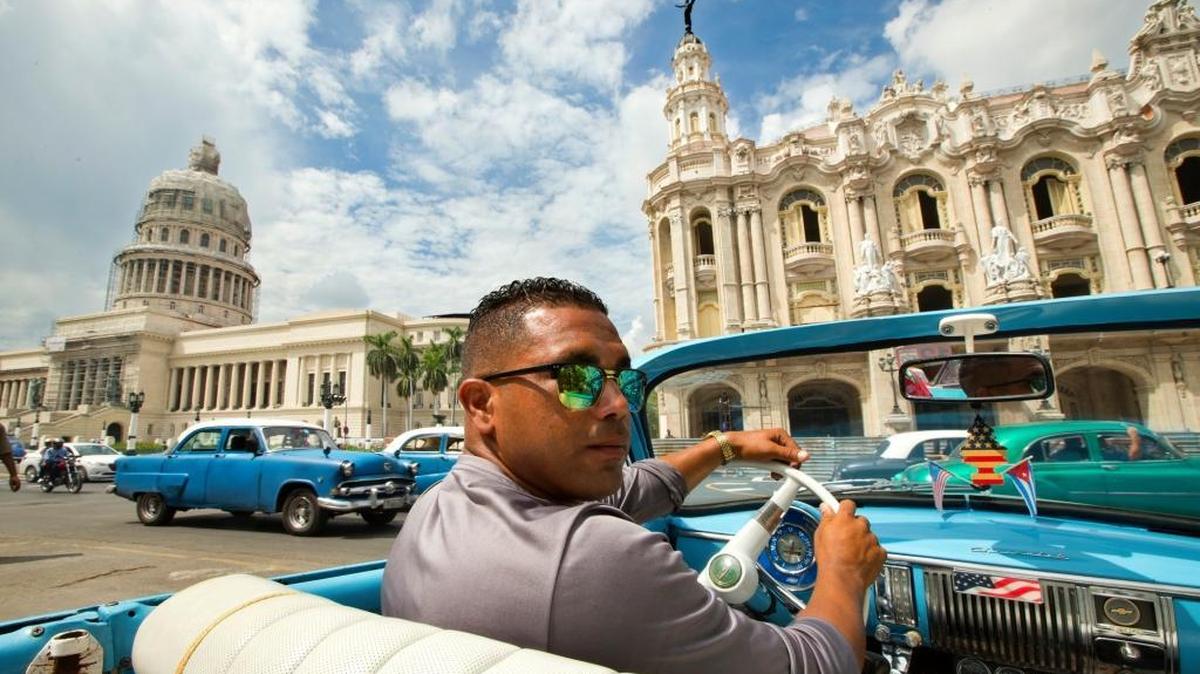 Julio Perez drives his 1950 Chevrolet convertible as he looks to provide taxi and tour service to tourists visiting Cuba on Thursday, Sept. 24, 2015.