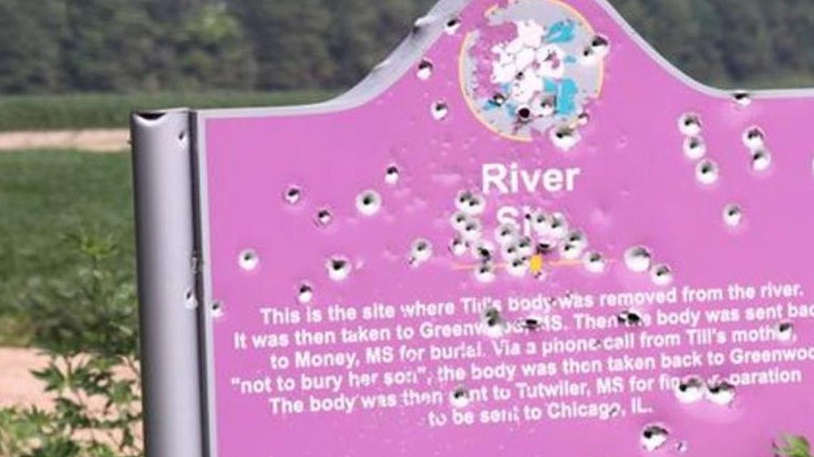 The sign marking where Emmett Till’s body was found in the Tallahatchie River in 1955 is cratered with bullets.