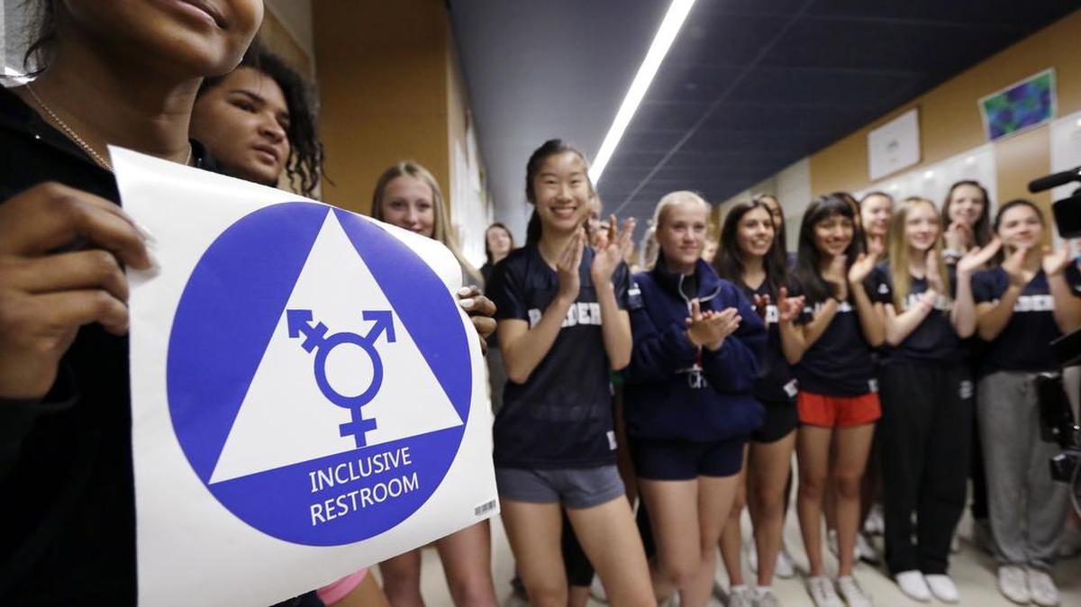 Students at Nathan Hale High School in Seattle proudly display a sticker for the school’s gender-neutral bathrooms .