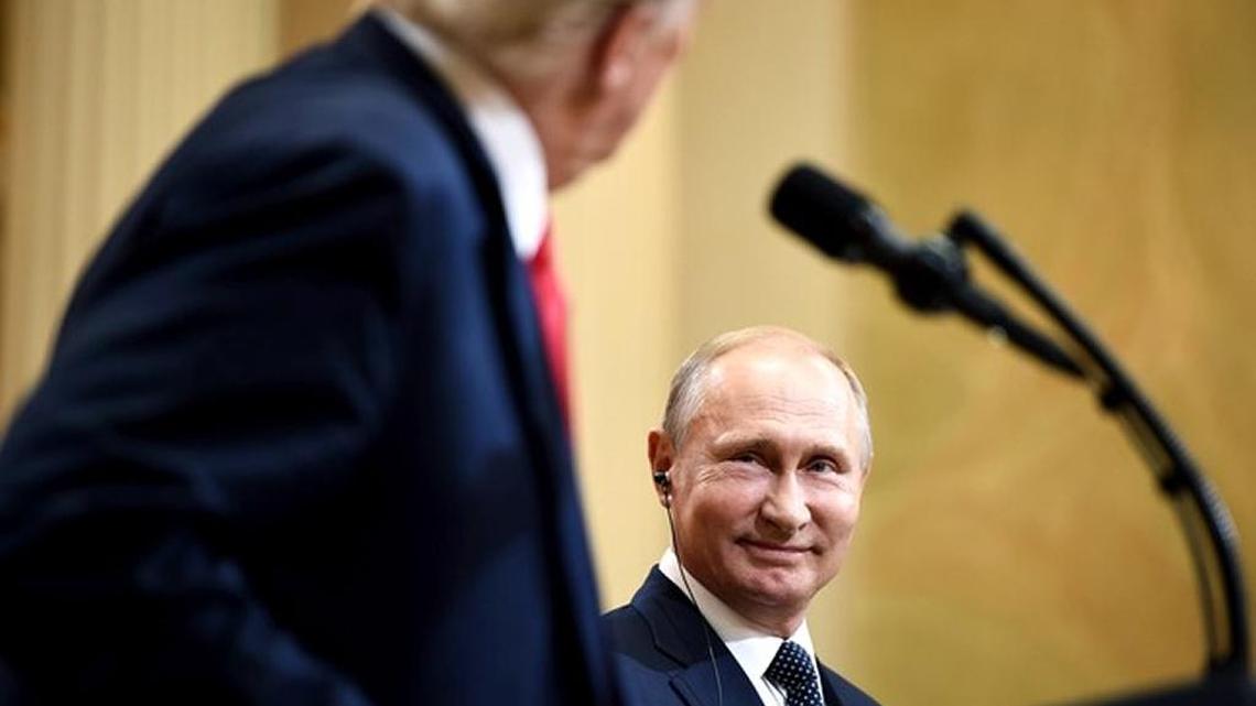Vladimir Putin smiles at a joint press conference after meeting with President Trump in Helsinki.