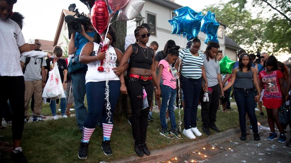 Kimberly O’Neal, center, sister of Sylville Smith, who was shot by Milwaukee police, stands with supporters during a vigil.