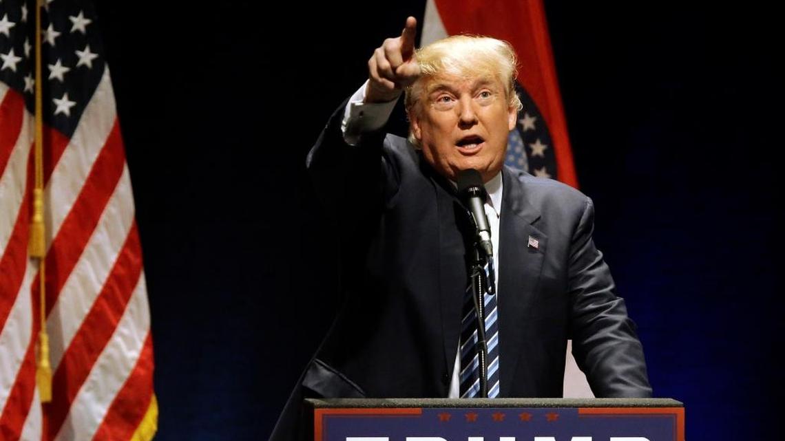 Donald Trump points to protesters who were causing a disturbance at a campaign rally in St. Louis. He has expressed sympathy for the anger some of his supporters feel regarding protestors.