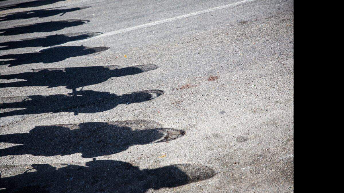 
ON GUARD: The shadows of Maryland state troopers on the ground near a pharmacy that was destroyed during rioting.
