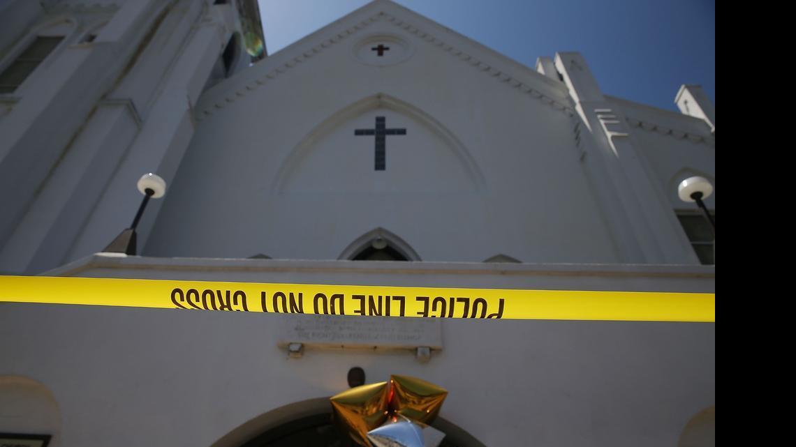 
Police tape stretches in front of Emanuel AME Church on June 18, 2015 in Charleston, South Carolina. Nine people were killed on June 17 in a mass shooting during a prayer meeting at the church. A 21-year-old suspect, Dylann Roof of Lexington, South Carolina, was arrersted Thursday during a traffic stop. Emanuel AME Church is one of the oldest in the South. 
