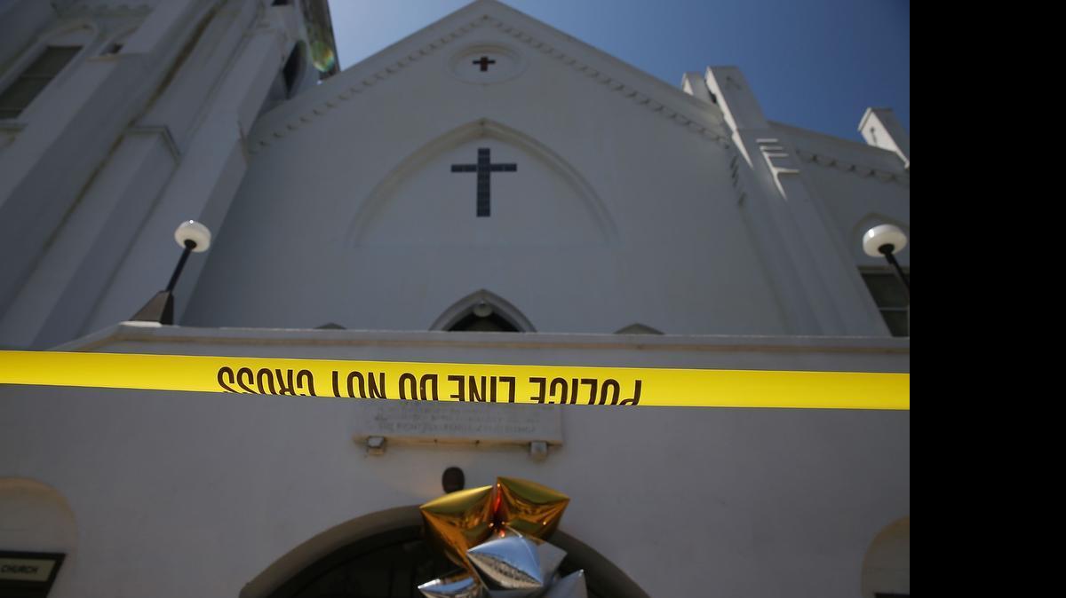 
Police tape stretches in front of Emanuel AME Church on June 18, 2015 in Charleston, South Carolina. Nine people were killed on June 17 in a mass shooting during a prayer meeting at the church. A 21-year-old suspect, Dylann Roof of Lexington, South Carolina, was arrersted Thursday during a traffic stop. Emanuel AME Church is one of the oldest in the South. 
