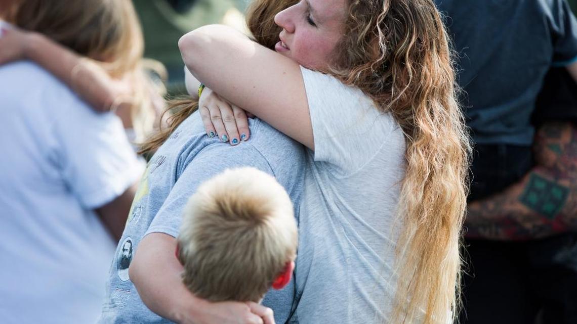 Two mothers hug after recovering their children following a shooting at Townville Elementary in Townville, S.C.