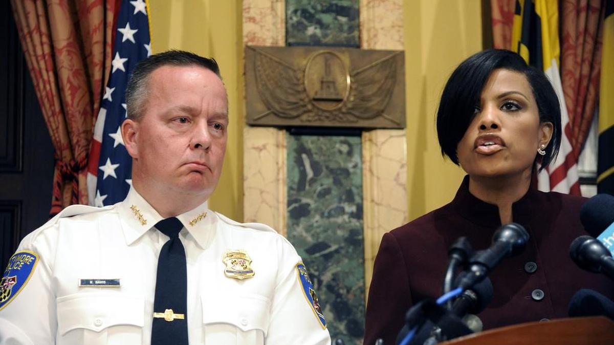 Baltimore Police Commissioner Kevin Davis listens as Mayor Stephanie Rawlings-Blake speaks about a Justice Department report on racism in the city’s police force.