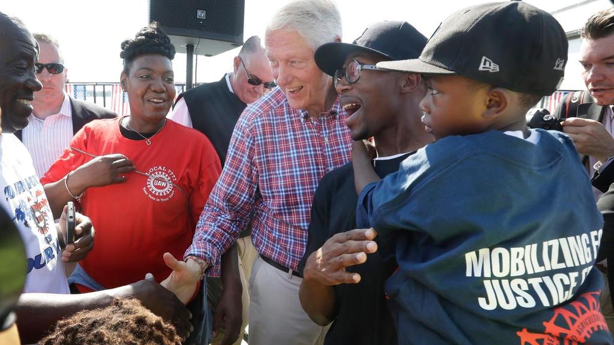 Bill Clinton greets union workers in Detroit on Monday. Some white politicians have stumbled when talking to black audiences.