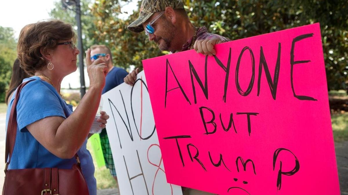 Robert Matt of Roanoke, right, a supporter of Democratic presidential candidate Hillary Clinton, talks to Susan Pyne, left, who plans to vote for Republican presidential nominee Donald Trump, on Monday, July 25, 2016.