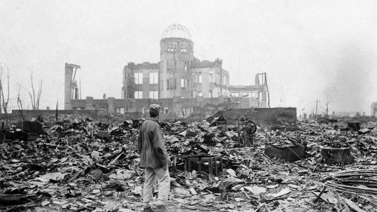 
This Sept. 8, 1945 picture shows an allied correspondent standing in the rubble in front of the shell of a building that once was a movie theater in Hiroshima, Japan, a month after the first atomic bomb ever used in warfare was dropped by the U.S. on Monday, Aug. 6, 1945. 

