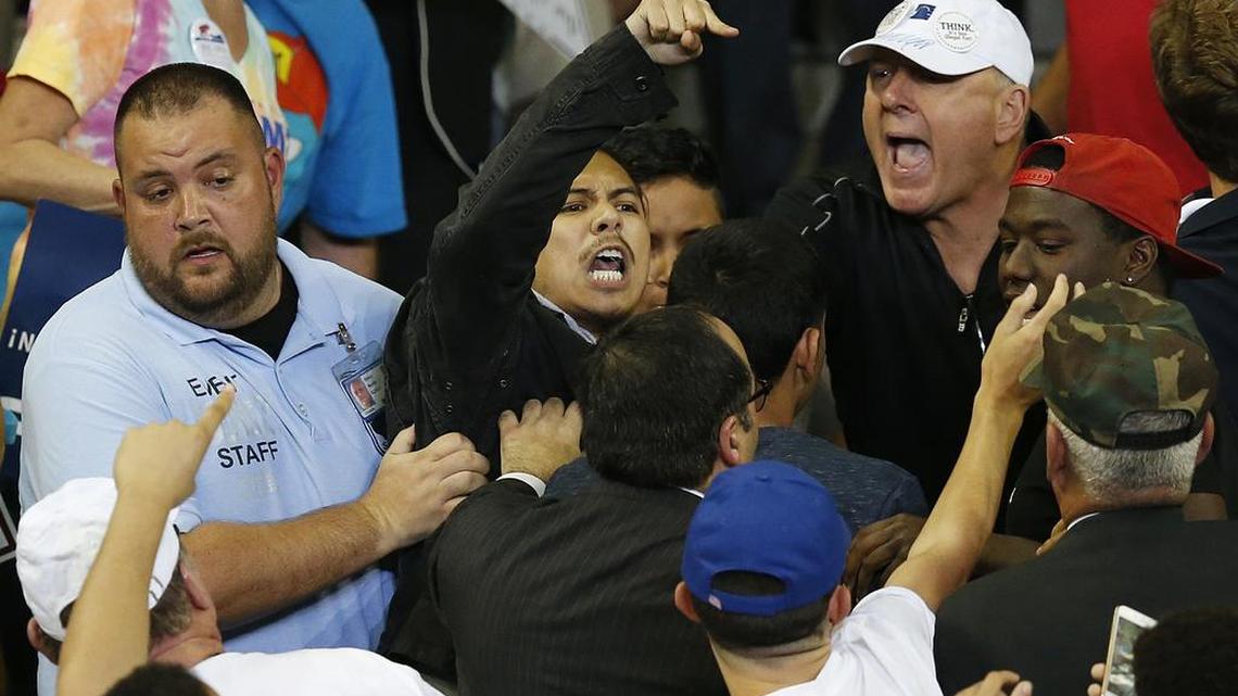 A man is removed as he protests Republican presidential candidate Donald Trump during a campaign rally in Orlando.