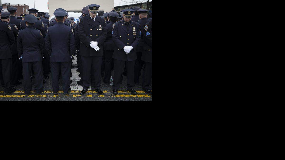 
NYPD: Some police officers turned their backs as Mayor Bill de Blasio spoke at the funeral of New York Police Department Officer Wenjian Liu on Sunday.
