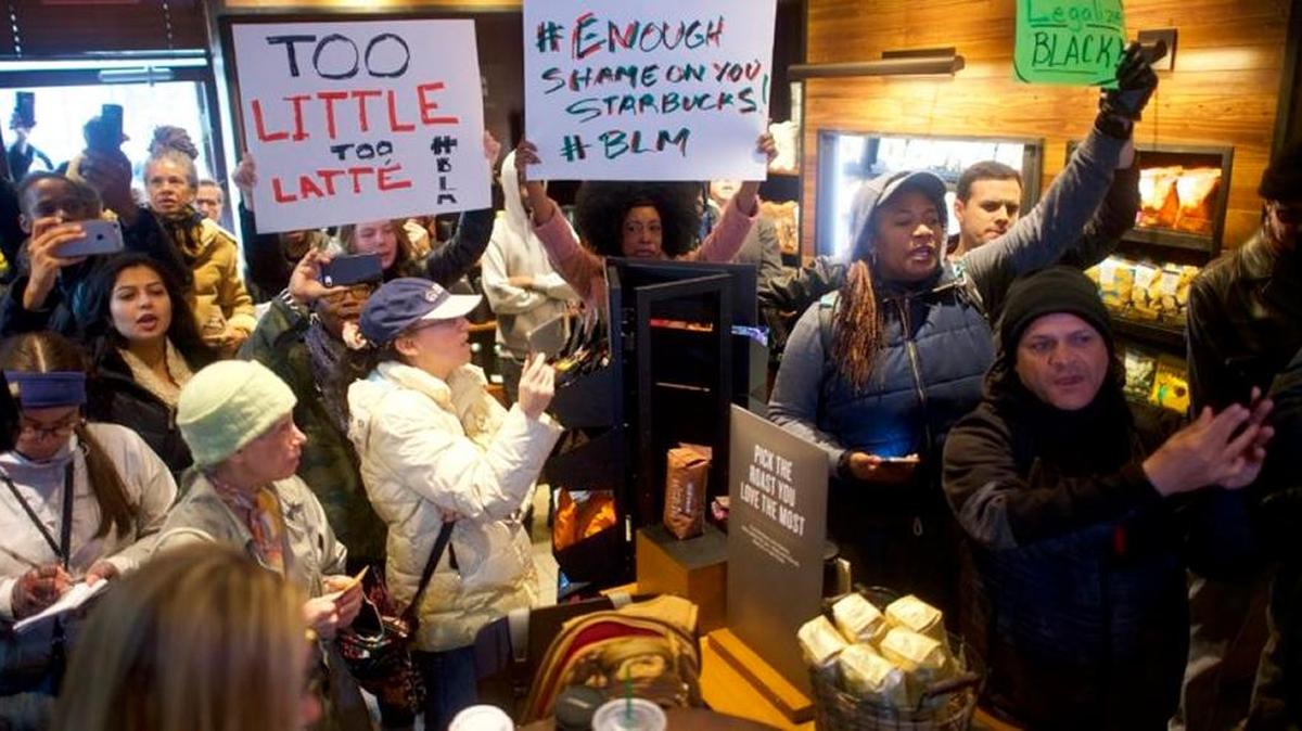 Demonstrators pack a Philadelphia Starbucks where police arrested two black men who were waiting for a friend inside.