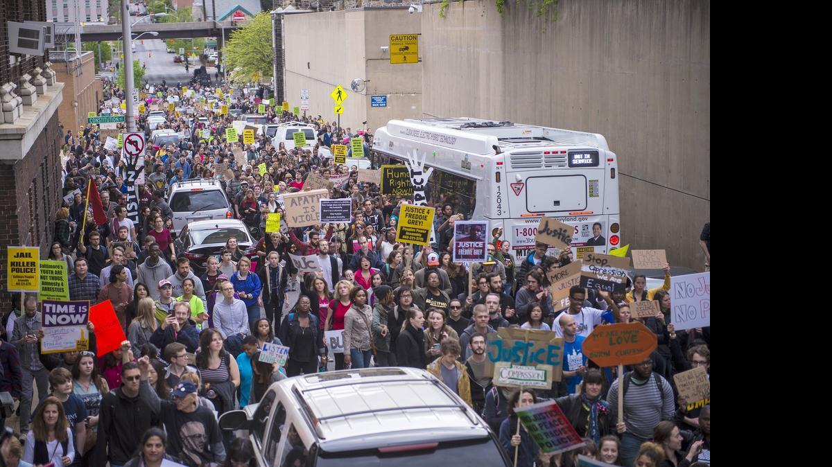 
Protesters march by the Baltimore Central Booking and Intake Center on May 1 after it was announced that criminal charges would be brought against six officers involved in the Freddie Gray case. 
