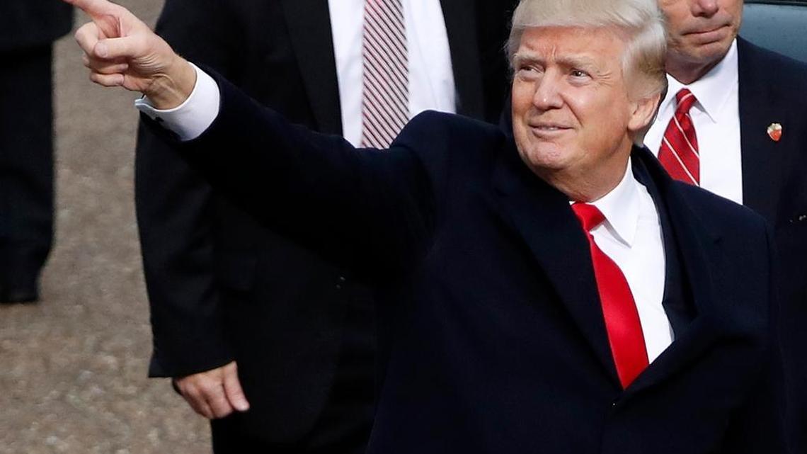 President Donald Trump points during his inauguration parade in Washington on Friday.