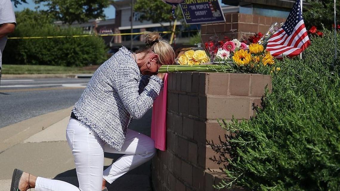 A woman mourns outside the offices of the Capital Gazette after a gunman killed five people.