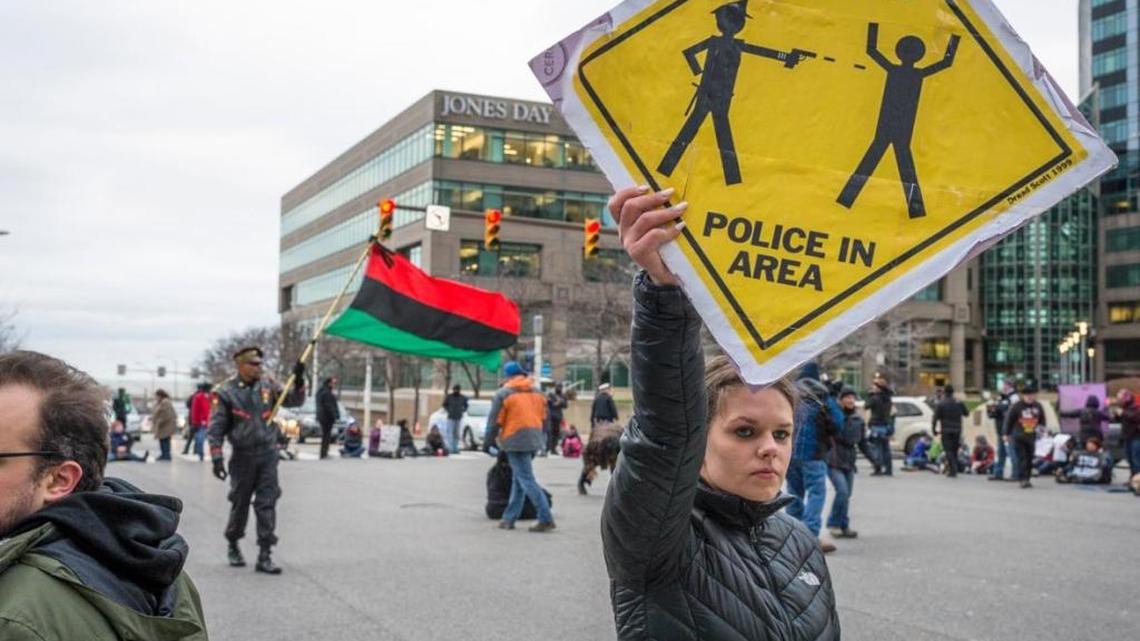 In 2015, Katy Kostenko, a 19-year old resident of Cleveland, held a sign in protest of police shootings.