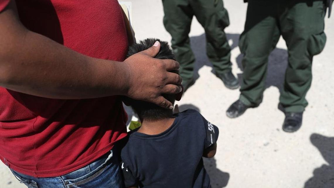 U.S. Border Patrol agents take a father and son from Honduras into custody at the U.S.-Mexico border near Mission, Texas.