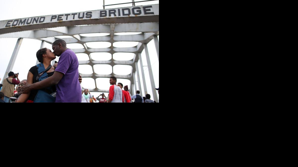
IN SELMA: A couple joins thousands of people who walked across the Edmund Pettus Bridge on Sunday.


