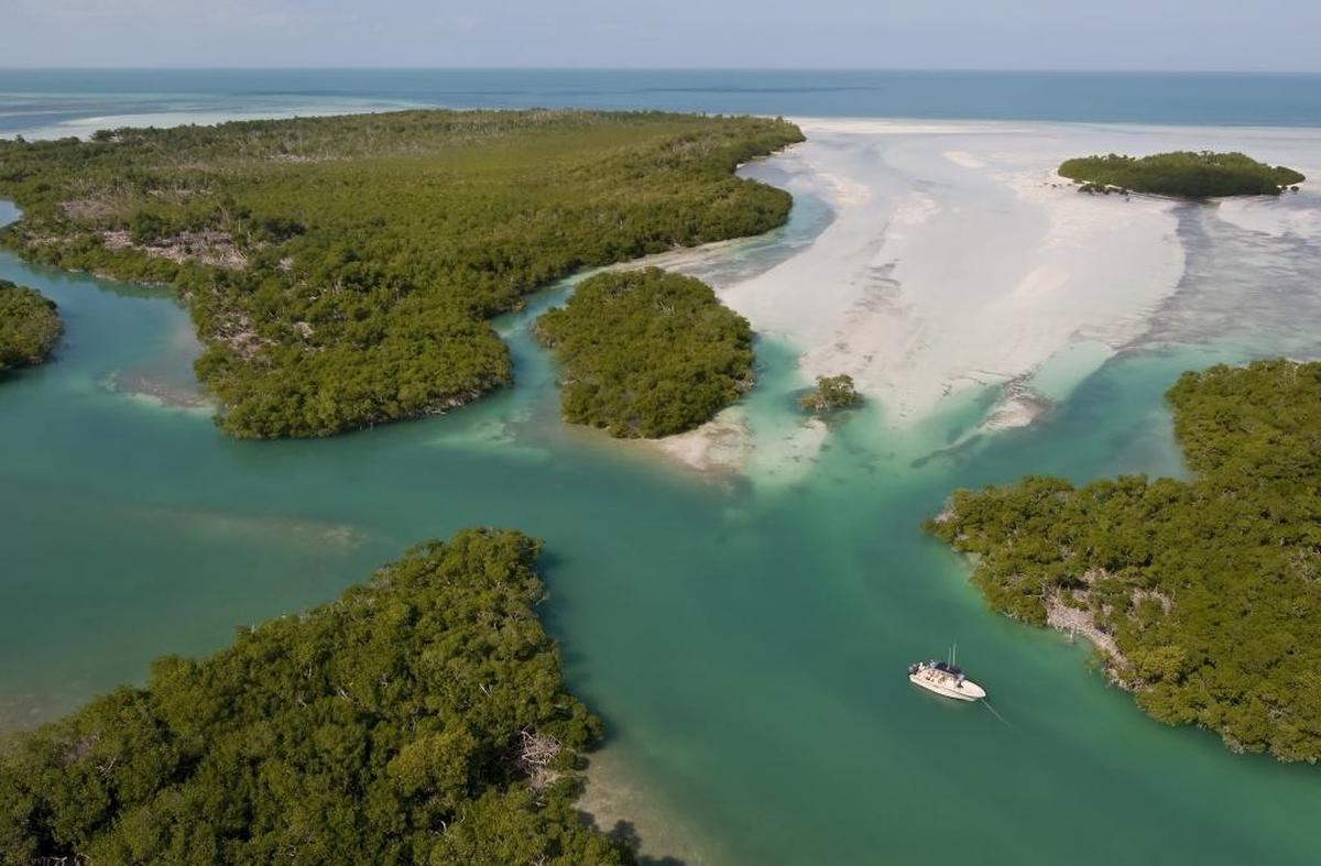 Anglers on a fishing boat are anchored in a channel among Snipe Keys, a cluster of islands that border the Gulf of Mexico off the Lower Florida Keys.