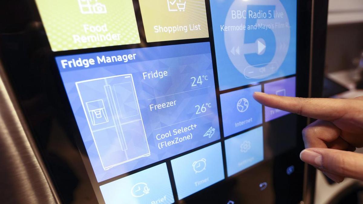 An employee at a John Lewis Plc department store in London demonstrates how to connect to the internet on a Samsung Electronics Co. Family Hub fridge freezer on April 8.
