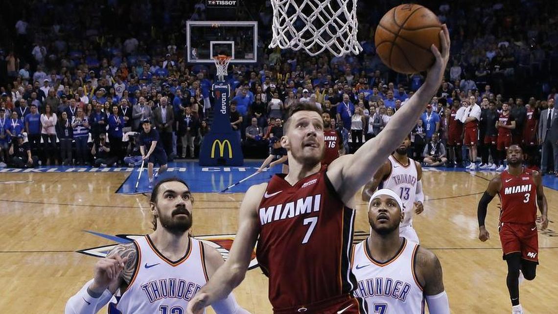 Miami Heat guard Goran Dragic (7) goes up for a shot in front of Oklahoma City Thunder center Steven Adams (12) and forward Carmelo Anthony (7) during the second half of an NBA basketball game in Oklahoma City, Friday, March 23, 2018.