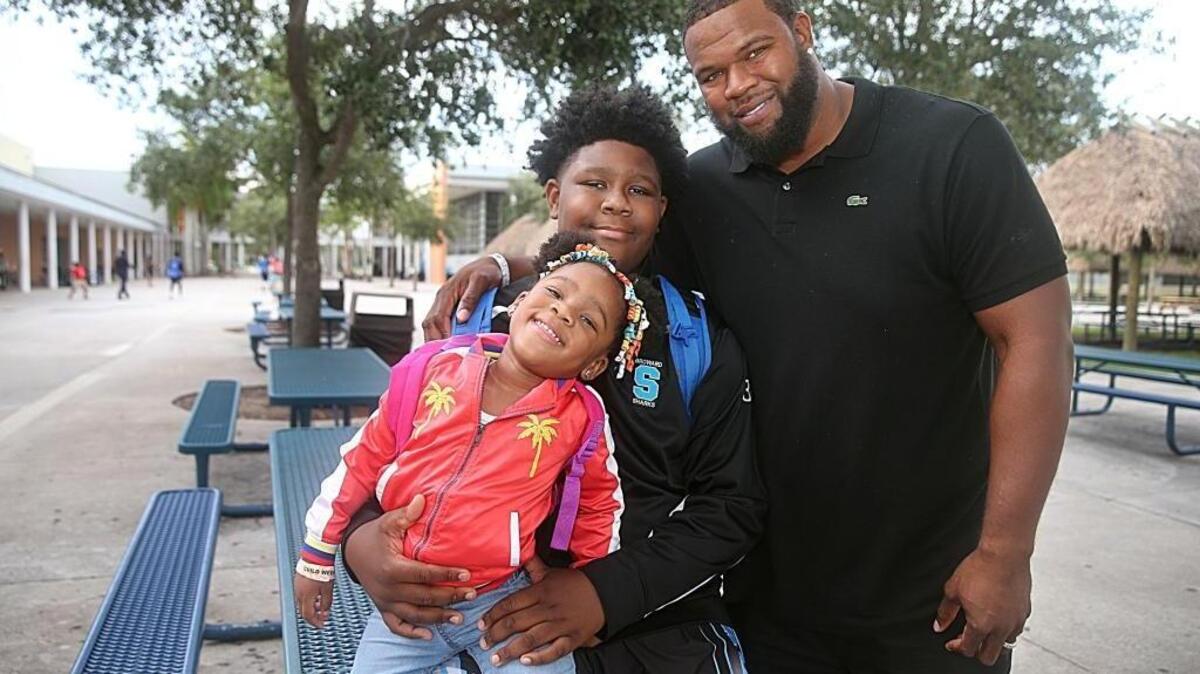 Former Miami Dolphin Vernon Carey posed with his 2-year-old daughter Dynver and his 11-year-old son, Jalen, who plays with the Broward Sharks, a basketball travel team. The Sharks played a state championship game at Cypress Bay High School in Weston on Friday, June 09, 2017.