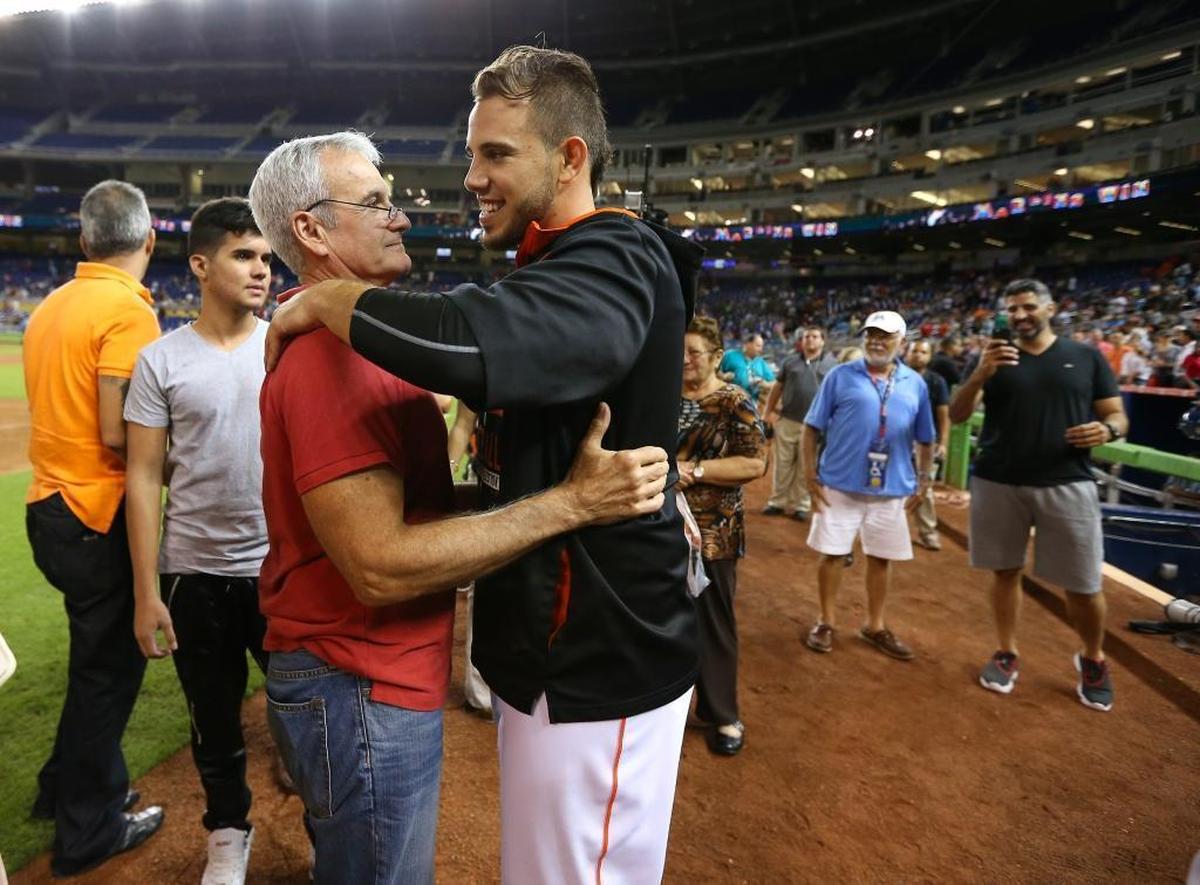 Marlins pitcher Jose Fernandez hugs his attorney Ralph Fernandez on Sept. 25, 2015, after becoming the first pitcher in the modern era to win his first 17 career home decisions.