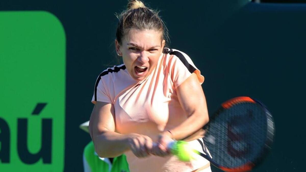 Simona Halep of Romania, current world No. 1 on the WTA Tour returns against Oceane Dodin of France, during the women’s single first round at the Miami Open tennis tournament in Key Biscayne on Thursday, March 22, 2018.