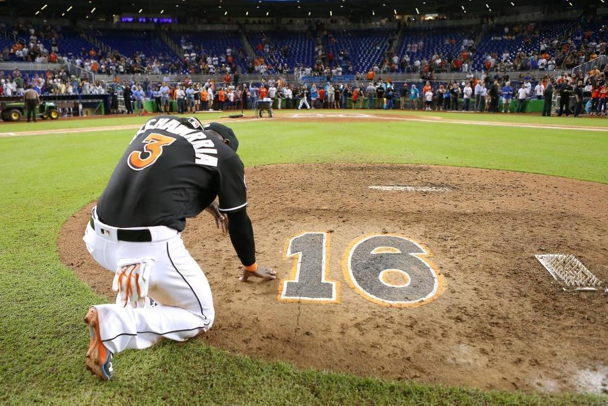 Marlins shortstop Adeiny Hechavarria prays while kneeling at the mound near Jose Fernandez’s No. 16 last year on Sept. 28.
