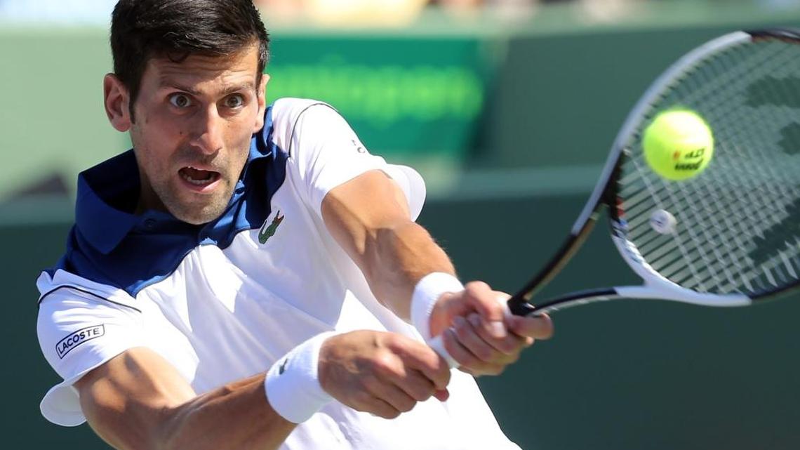 Novak Djokovic returns a ball as he plays Benoit Paire at the 2018 Miami Open on Key Biscayne, Fla., March 23, 2018.