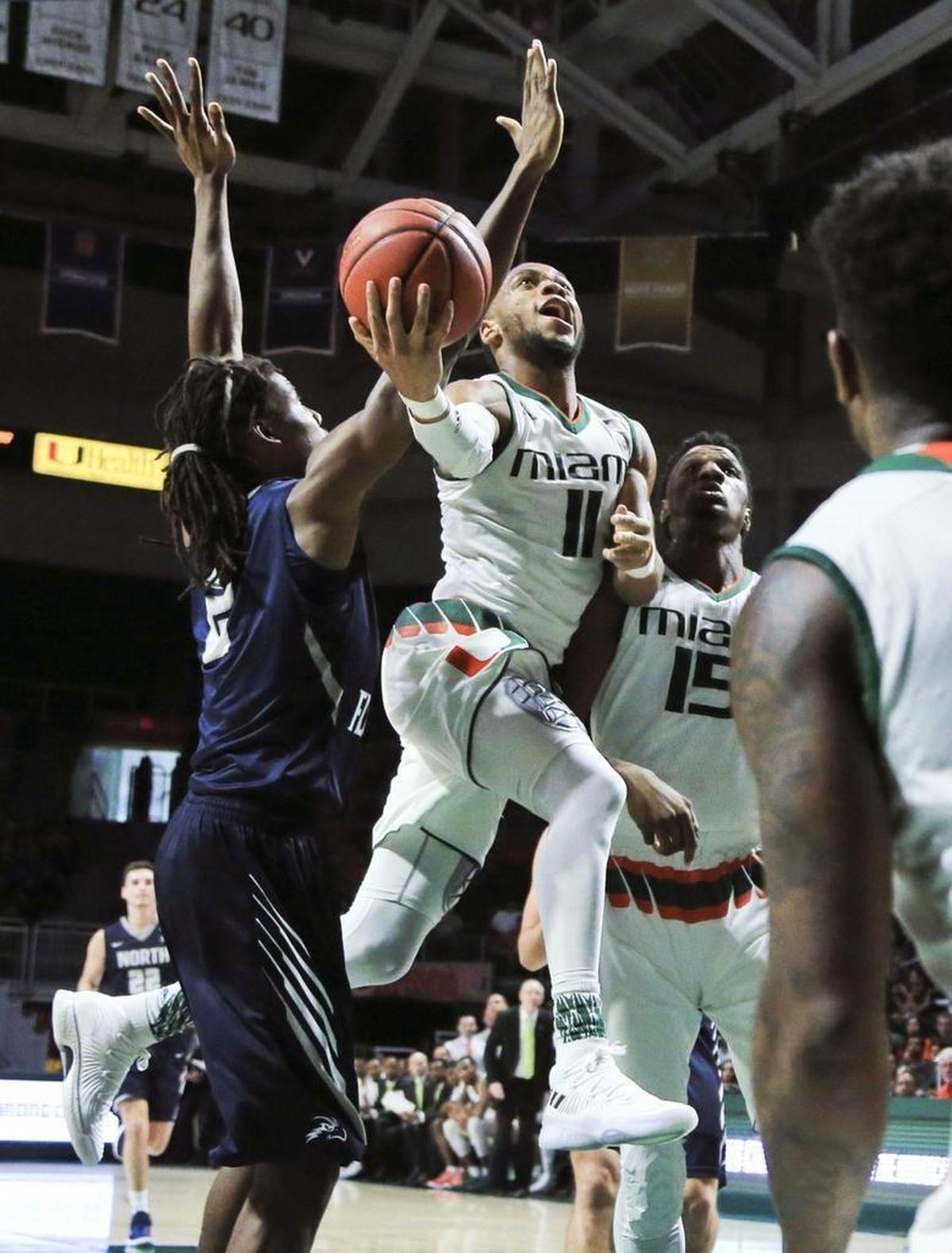 Miami Hurricanes guard Bruce Brown Jr. (11) drives to the basket in the first half as the University of Miami Hurricanes host the North Florida Ospreys on Saturday, Nov. 25, 2017.