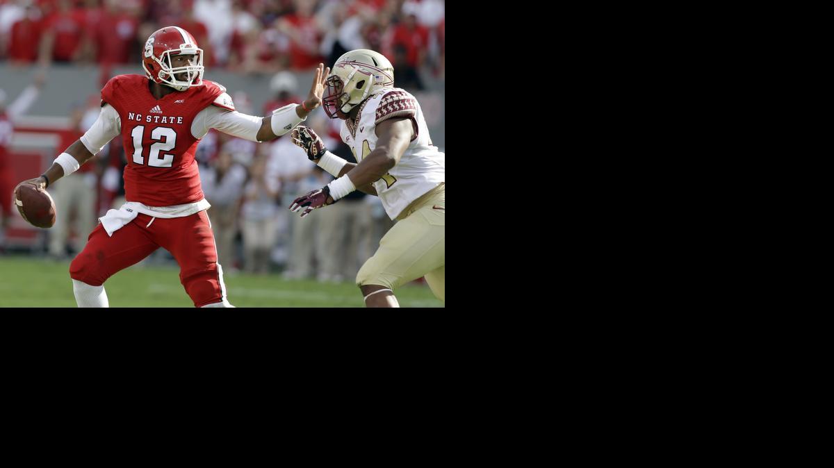 
Florida State's DeMarcus Walker (44) rushes North Carolina State quarterback Jacoby Brissett (12) during the first half of an NCAA college football game in Raleigh, N.C., Saturday, Sept. 27, 2014.
