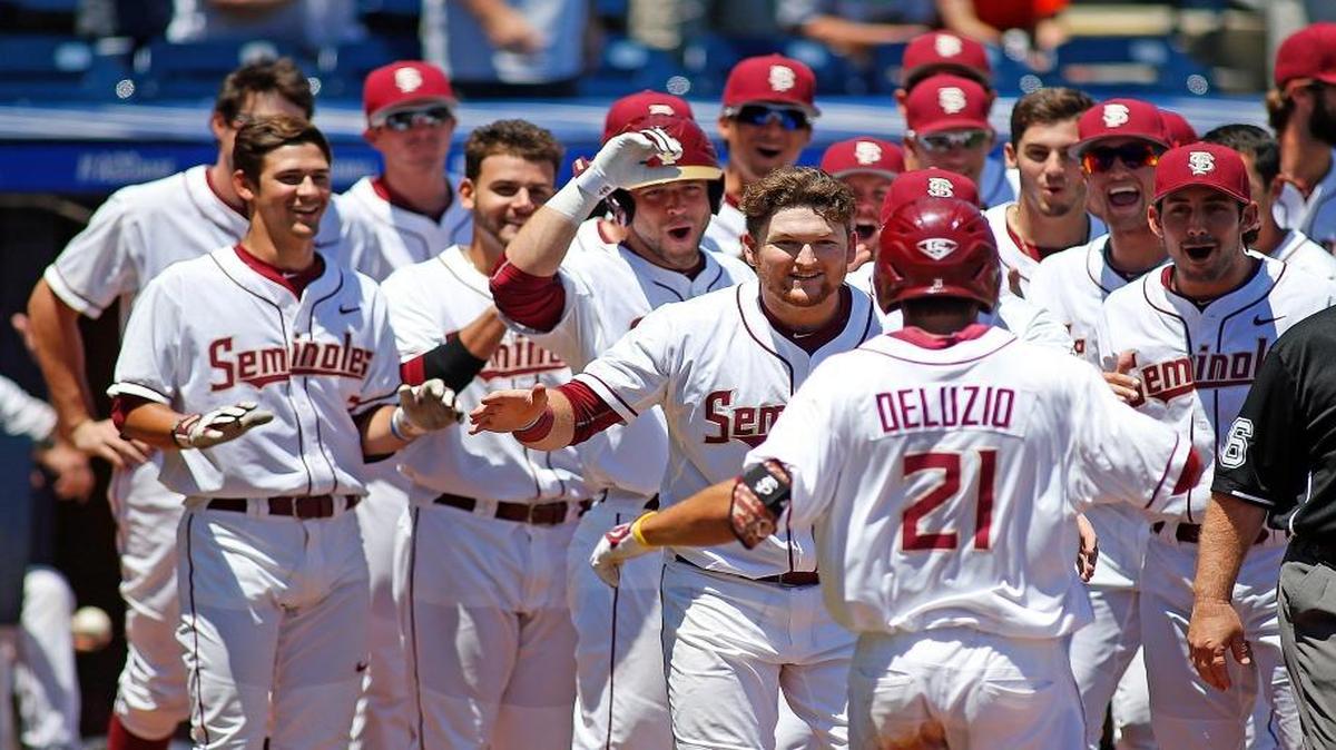 Florida State's Ben DeLuzio (21) is congratulated by teammates after hitting a solo home run against Louisville during the the bottom of the eighth inning of an NCAA college ACC tournament baseball game Saturday, May 23, 2015, in Durham, N.C. Florida State won 6-0 to advance to the finals Sunday.