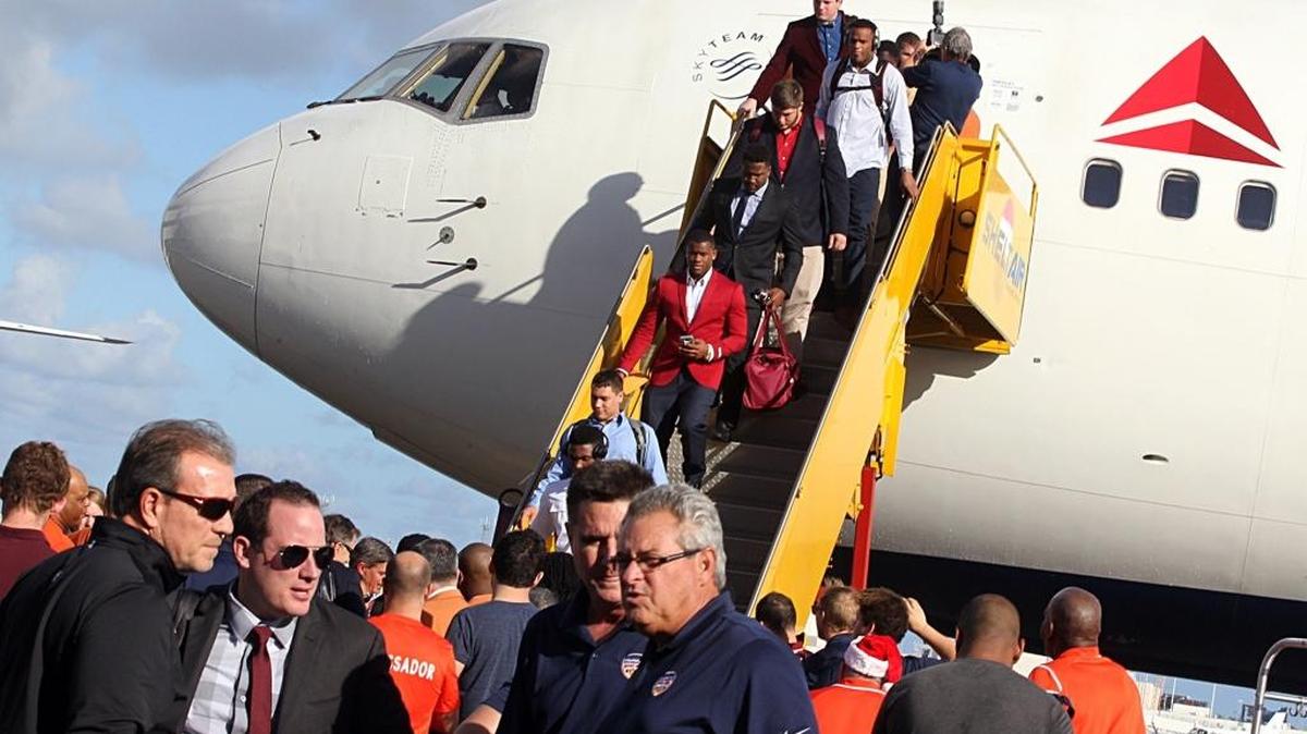 FSU coach Jimbo Fisher, far, left, and the rest of the FSU team arrive at Fort Lauderdale Airport on Saturday, Dec. 24, 2016. FSU will face Michigan in the Orange Bowl on Friday.