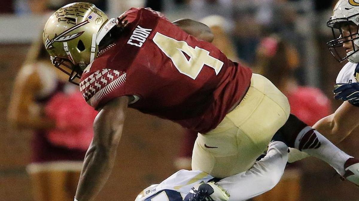 Florida State running back Dalvin Cook runs against Georgia Tech defensive back Lawrence Austin during the first half of their matchup on Oct. 24 in Atlanta.