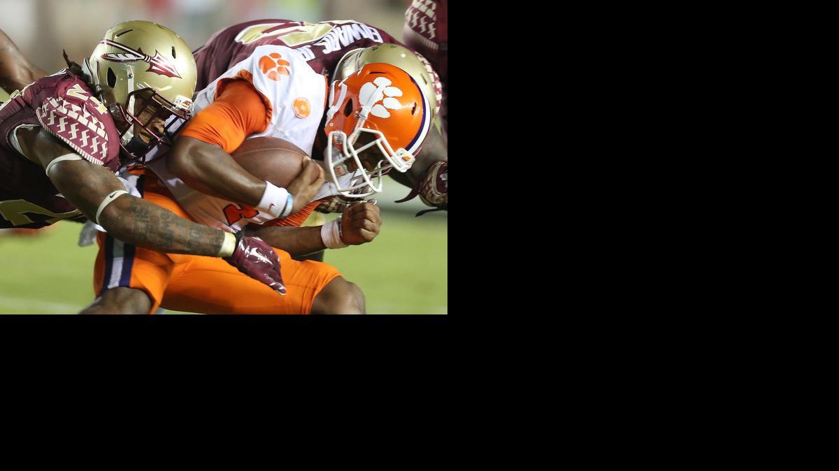 
Florida State linebacker Terrance Smith, left, sacks Clemson quarterback Deshaun Watson during the first half of Saturday night’s overtime victory in Tallahassee. The Noles are now 3-0.
