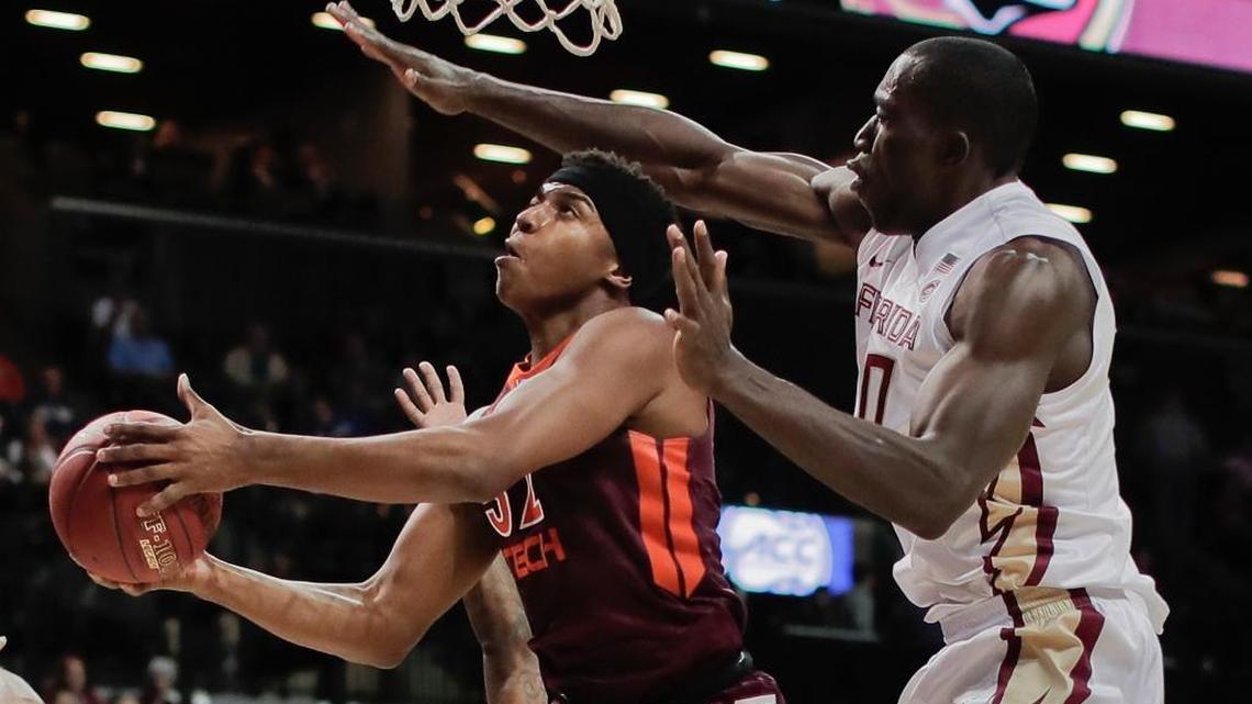 Virginia Tech forward Zach LeDay (32) puts up a shot against Florida State center Michael Ojo (50) in the first half of an NCAA college basketball game during the quarterfinals of the Atlantic Coast Conference tournament, Thursday, March 9, 2017, in New York.