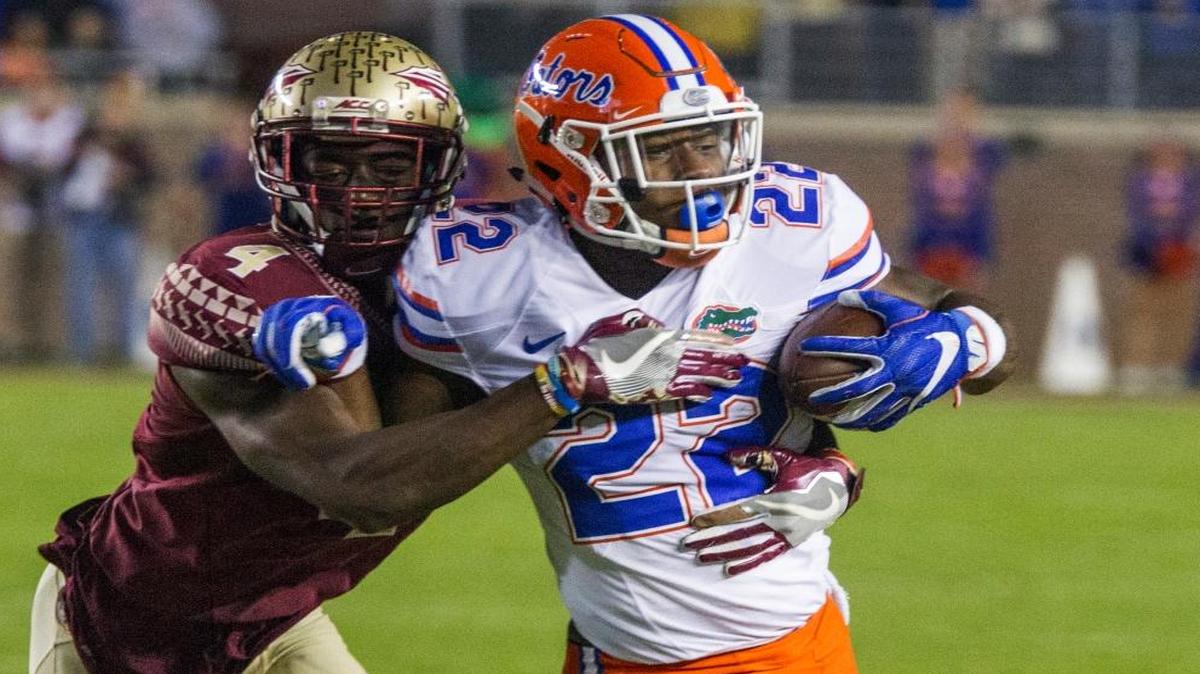 Florida State's Tarvarus McFadden (4) tackles Florida's Lamical Perine (22) during the first quarter of an NCAA college football game in Tallahassee, Fla., Sat., Nov. 26, 2016.