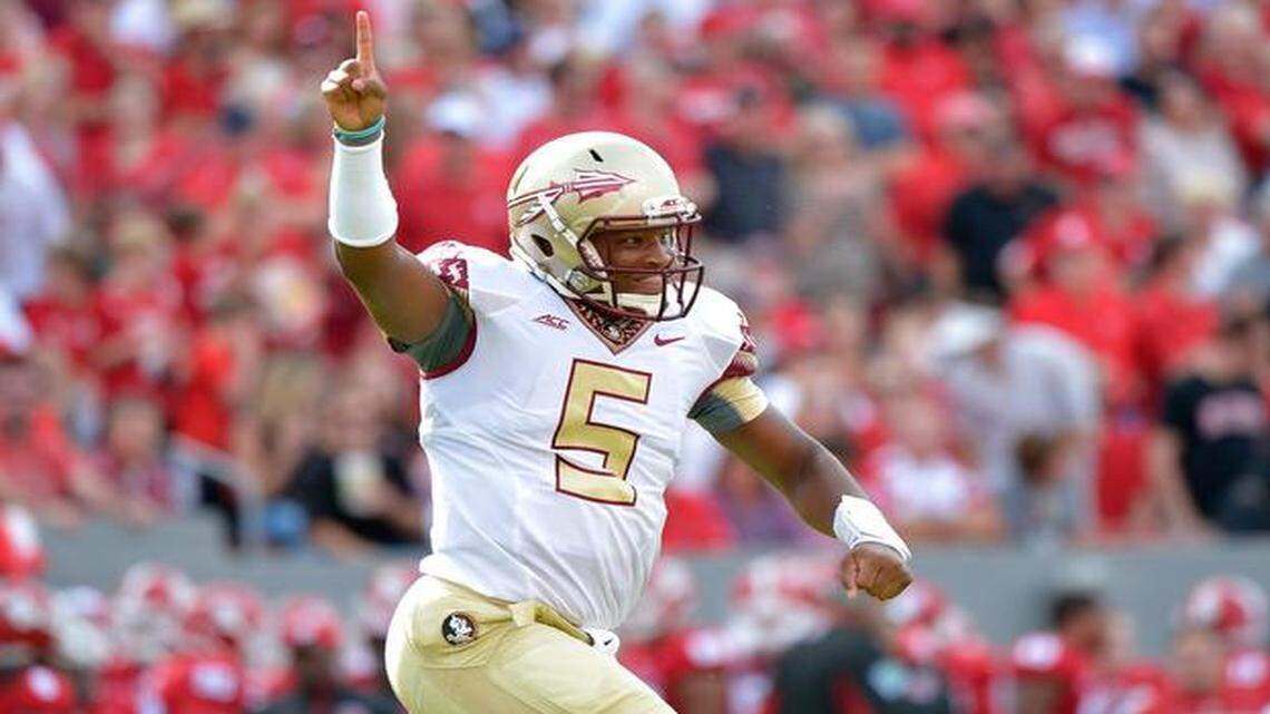 leading man:  Jameis Winston celebrates after throwing one of his four touchdowns against the N.C. State on Saturday.