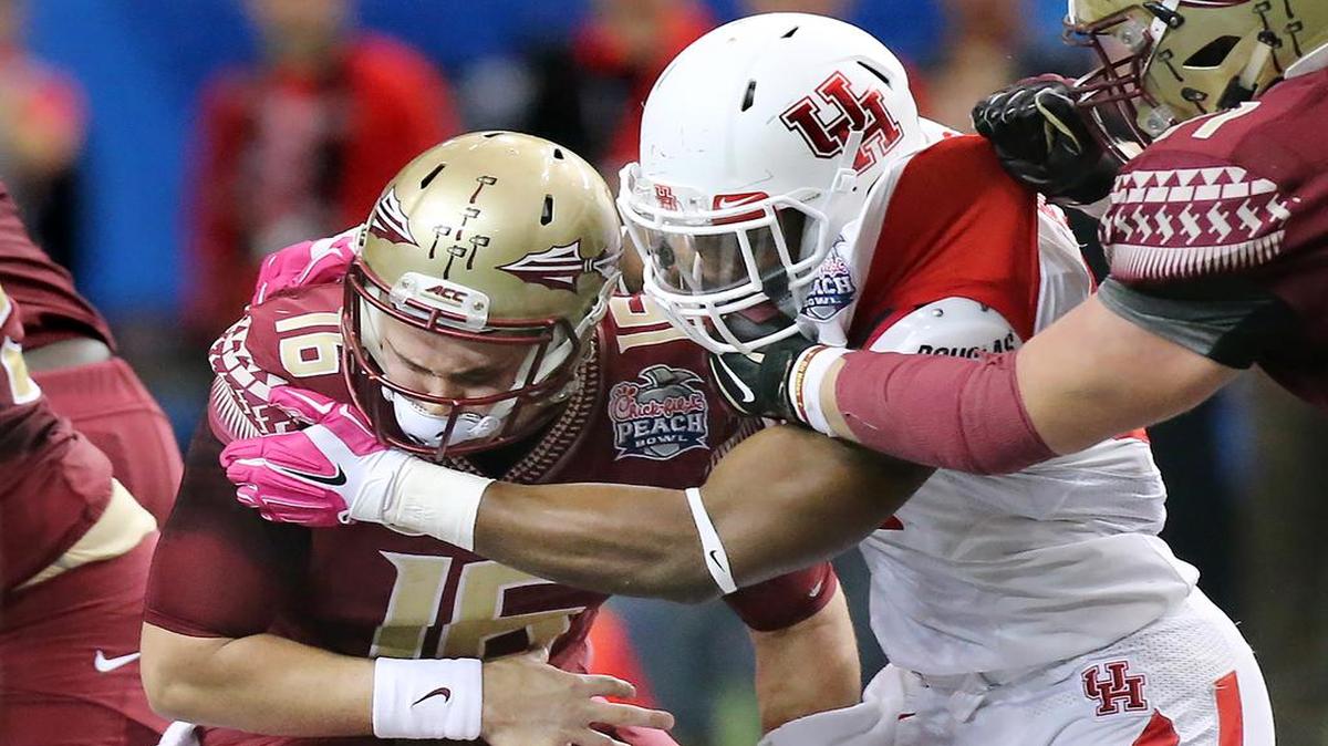 FSU quarterback J.J. Cosentino gets sacked by Houston’s Tyus Bowser during the Peach Bowl on Thursday. Cosentino had to come in for an injured Sean Maguire, who returned and threw four interceptions in the loss.